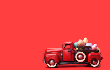 Red retro truck carrying Easter eggs on a red background. space for text. Happy Easter holiday concept.