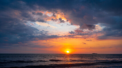 Fototapeta na wymiar Sunset in the sea with dramatic sky