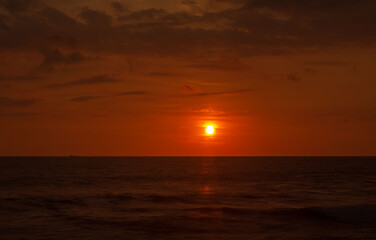 Red sunset over ocean. Beautiful evening sky