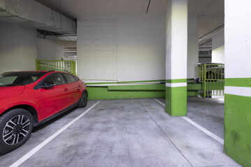 Ground floor of a building with a garage and parked vehicles