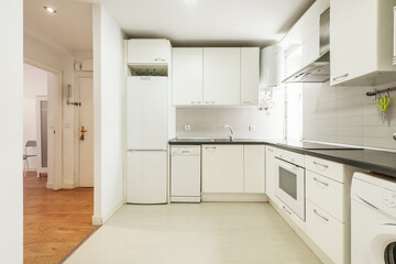 kitchen with smooth white cabinets, gray stone countertops, white tile, and built-in appliances