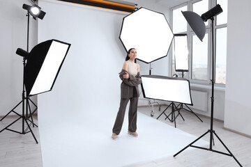 Beautiful young model posing in modern studio. Professional photo session