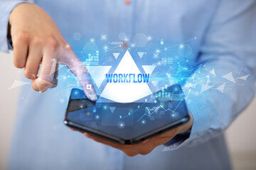 Businessman holding a foldable smartphone, business concept