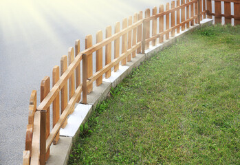 Small wooden fence near green grass outdoors