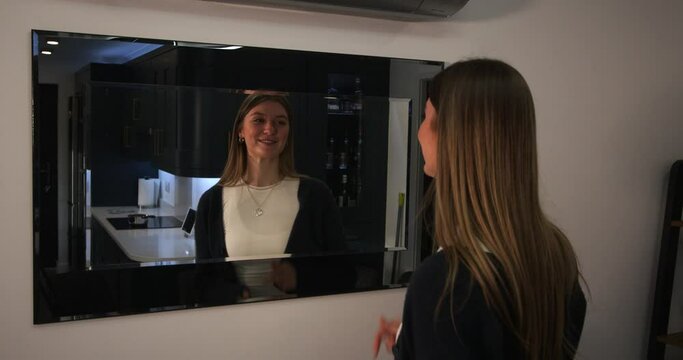 female model looking at herself, reflection and sorting out her hair in a mirror with cringe worthy reaction at end