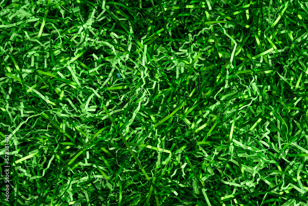 Wall mural Easter grass, strips of green foil and lighter green paper, as a green background
