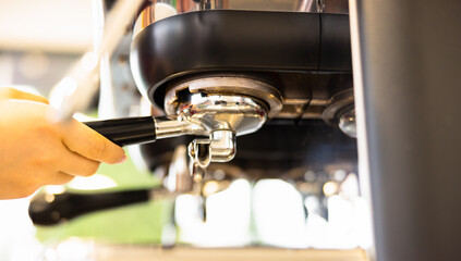 Close up photo of automatic coffee machine prepare aromatic coffee espresso in a small coffee shop.