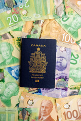  Canadian passport on top of a background of Canadian currency.