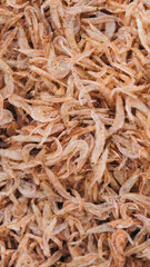 Plenty of dry shrimp background market for sell. Close-up pile texture detail bright light pink pale tone. Vertical format banner wallpaper cute