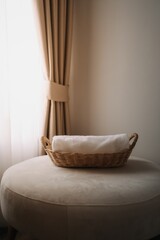 Neatly rolled towels in the basket of a hotel room.