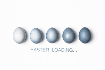Dyed blue gradient Easter eggs row on white. Easter loading concept. Creative greeting card, minimal.