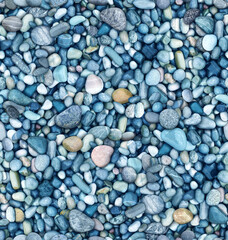 Seamless colorful large stones of different shapes on close-up. there are a lot of small stones nearby.

