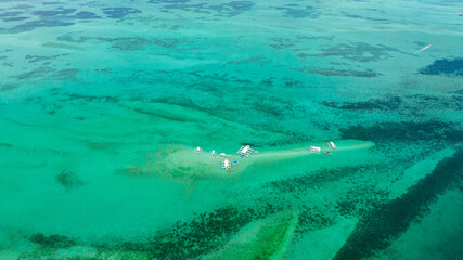 Fototapeta premium Sandbar and coral reef in turquoise water. Negros, Philippines.