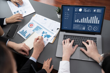 Closeup on meeting desk with businesspeople analyzing business marketing strategy with hands...