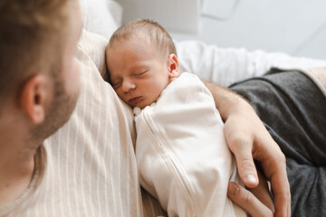 Unrecognizable man, father,holding child, caucasian hairy brunet cute newborn baby sleeping.One or...
