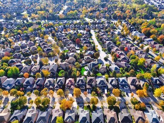 Aerial view of residential community neighborhood under autumn fall colors. Typical North America, Canada houses and streets drone shot background