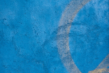 Blue concrete wall with yellow marks background texture