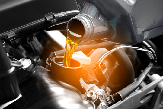 Refueling and pouring oil quality into the engine motor car Transmission and Maintenance Gear .Energy fuel concept. - Powered by Adobe