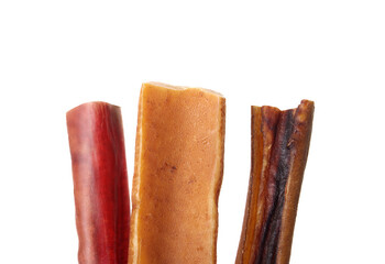 Variety of dog chew sticks. Close up of beef bully stick, yak milk bone and beef check stick for strong chewer. Natural behavioral enrichment for dogs and dental and mental health. Selective focus.