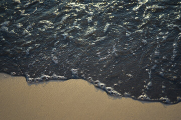 oil pollution on surface of sea at beach sand