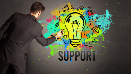 businessman drawing colorful light bulb