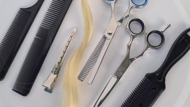 Set of hairdresser tools and hair. Shiny steel scissors and comb ready to use concept