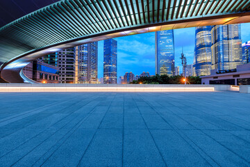 Empty square floor and bridge with modern buildings in Shanghai at night, China.
