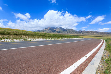 Asphalt road with mountain natural scenery in Xinjiang, China.
