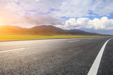 Asphalt road with mountain natural scenery in Xinjiang, China.