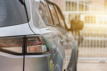 Rear image of a gray car parked in a house On a sunny summer day,  Rear view.