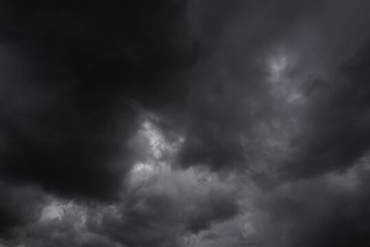 Dramatic dark storm rain clouds black sky background. Dark thunderstorm clouds rainny atmosphere. Meteorology danger windstorm disasters climate. Dark cloudscape storm disaster gloomy gray cloud sky