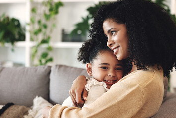 Fototapeta Hug, love and black family by girl and mother on a sofa, happy and relax in their home together. Mom, daughter and embrace on a couch, cheerful and content while sharing a sweet moment of bonding obraz