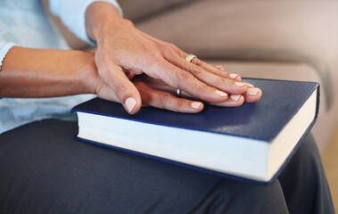 Bible, prayer and hands of old woman in living room for religion, book and Christian faith. Spiritual, God and worship with senior lady praying with holy text at home for wellness, believe and goal