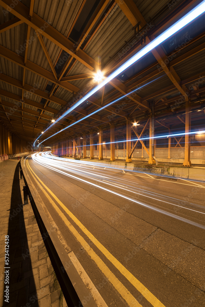 Poster light trails and head lights of traffic in tunnel. transportation background
