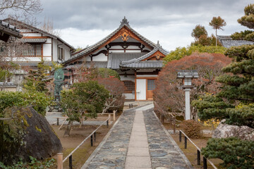 Fototapeta na wymiar Traditional wooden buddhist temple building exterior architecture and garden of the Tenryu-ji Buddhist temple in Kyoto Japan