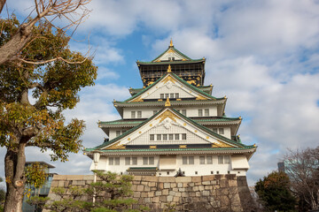 Green and white traditional Japanese architecture building of the Osaka Castle in Osaka Japan