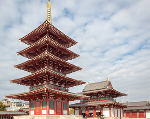 Red and gold colorful temple traditional architecture building and pagoda at the Shi-Tennoji Buddhist Temple in Osaka Japan
