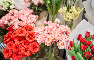 Flower shop concept. Different varieties fresh spring flowers in refrigerator room for flowers. Bouquets on shelf, florist business