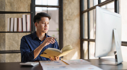 Mad crazy man employee sitting in office workplace with sticky notes all around, shouting furious angry, pissed off deadline and stressful job at office