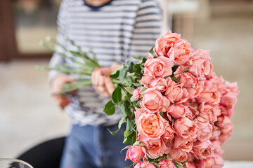 Bush rose Juliet. Florist prepares flowers. Fresh delivery in flower shop. European floral shop....