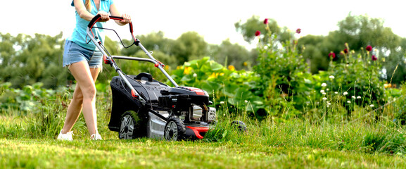 a girl mows the lawn with a lawn mower - obrazy, fototapety, plakaty
