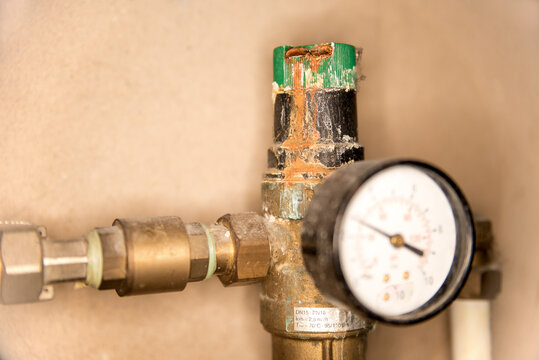 Decaying backwash water filter with pressure regulator and manometer that needs urgent replacement