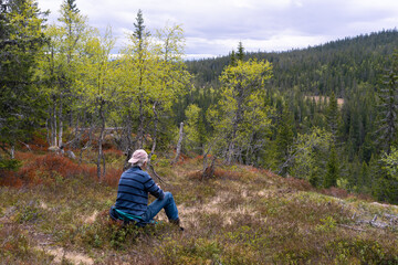 Having a rest in the Svartdalstjerna Forest Reserve, part of the Totenaasen Hills, Norway.