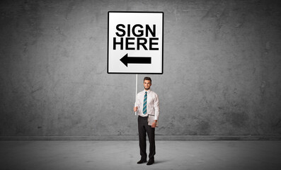 business person holding a traffic sign