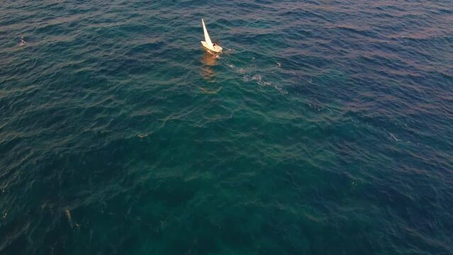 training of children on sailing boats optimist in Mediterranean sea