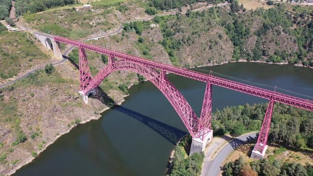Picturesque summer landscape of Truyere river with Garabit Viaduct, French railway arched viaduct in Cantal department