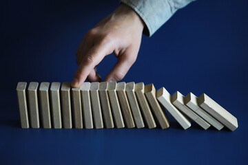 Closeup thick domino wood block in a row stop the falling, be stable in crisis, business solution...