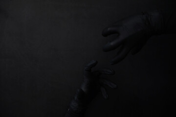 Obraz na płótnie Canvas Background of hands in gloves. Black gloves. Hand gestures in black gloves.