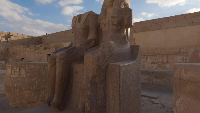 Ancient statues at mortuary temple of Ramesses III, Medinet Habu; Luxor, Egypt