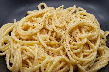Spaghetti cacio e pepe isolated on white background.